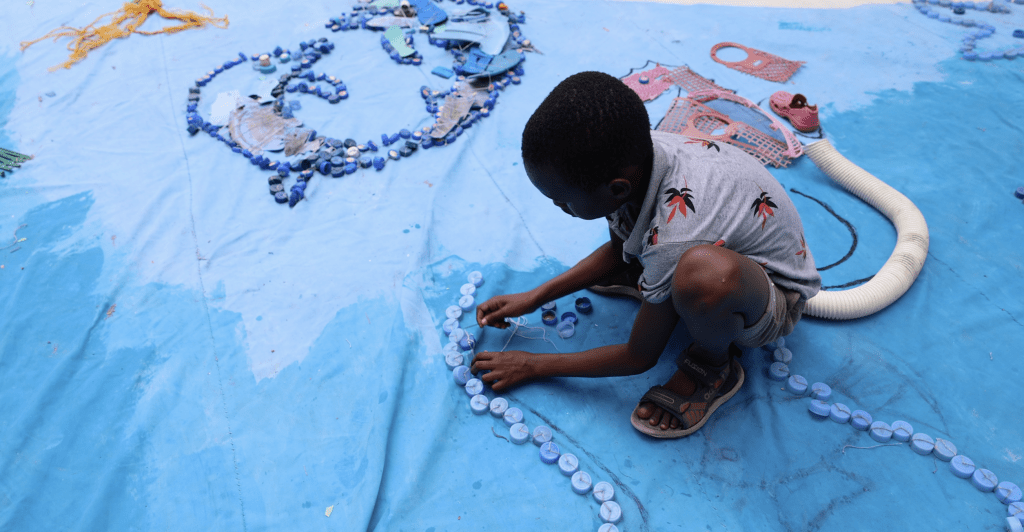 Orphanage children making recycled art