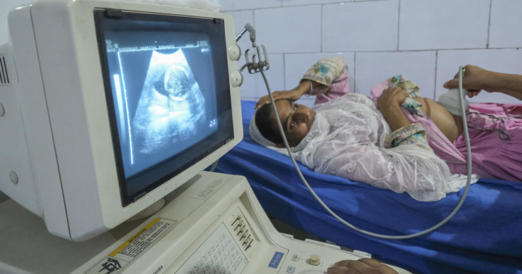 5 month Pregnant Akhtar Be (21) getting her Ultrasonography done by Dr.Sudheshwar Kumar (51) Medical Officer in Community Health Centre, Surnakote Jammu India. India newborn action plan (INAP) midterm review
