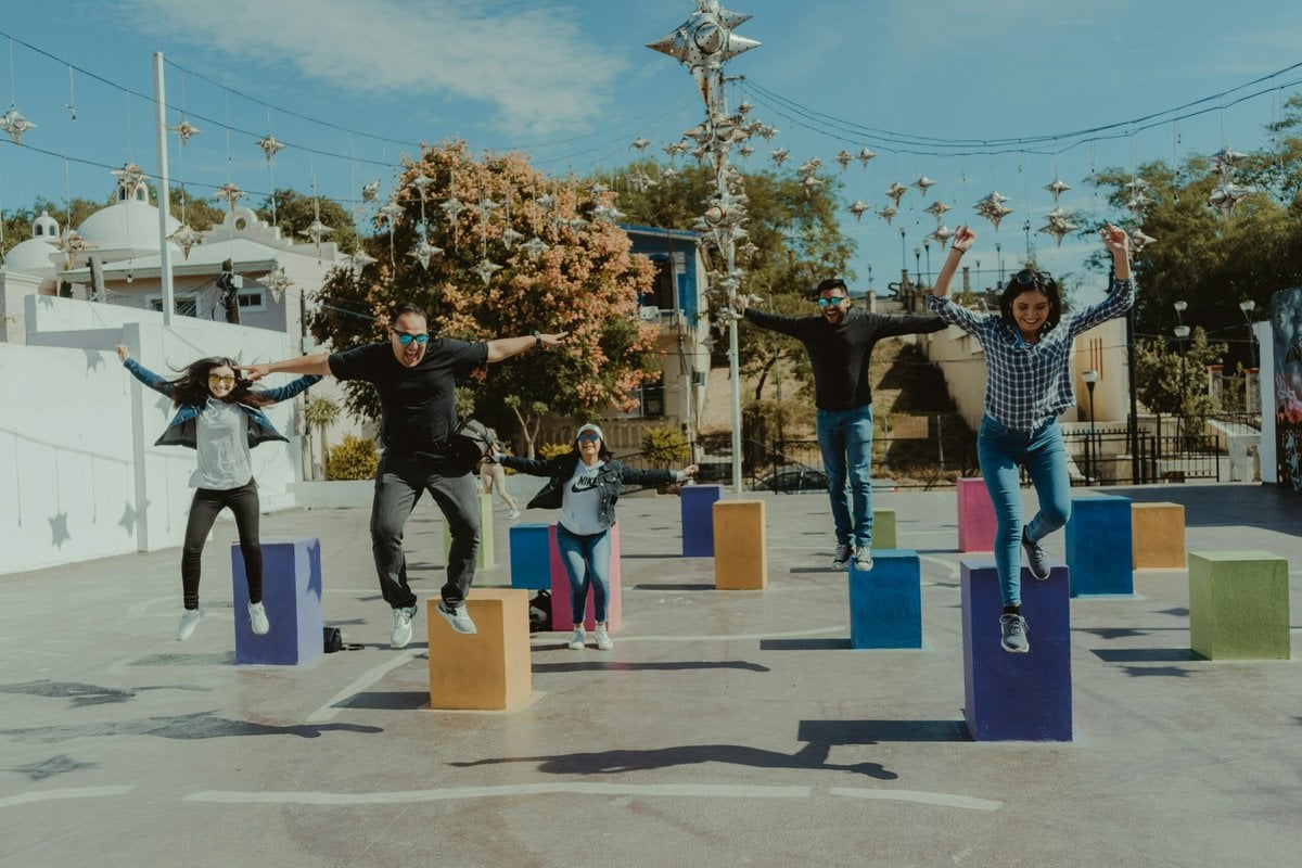 Gute Nachrichten, Menschen freuen sich und hüpfen über Hindernisse